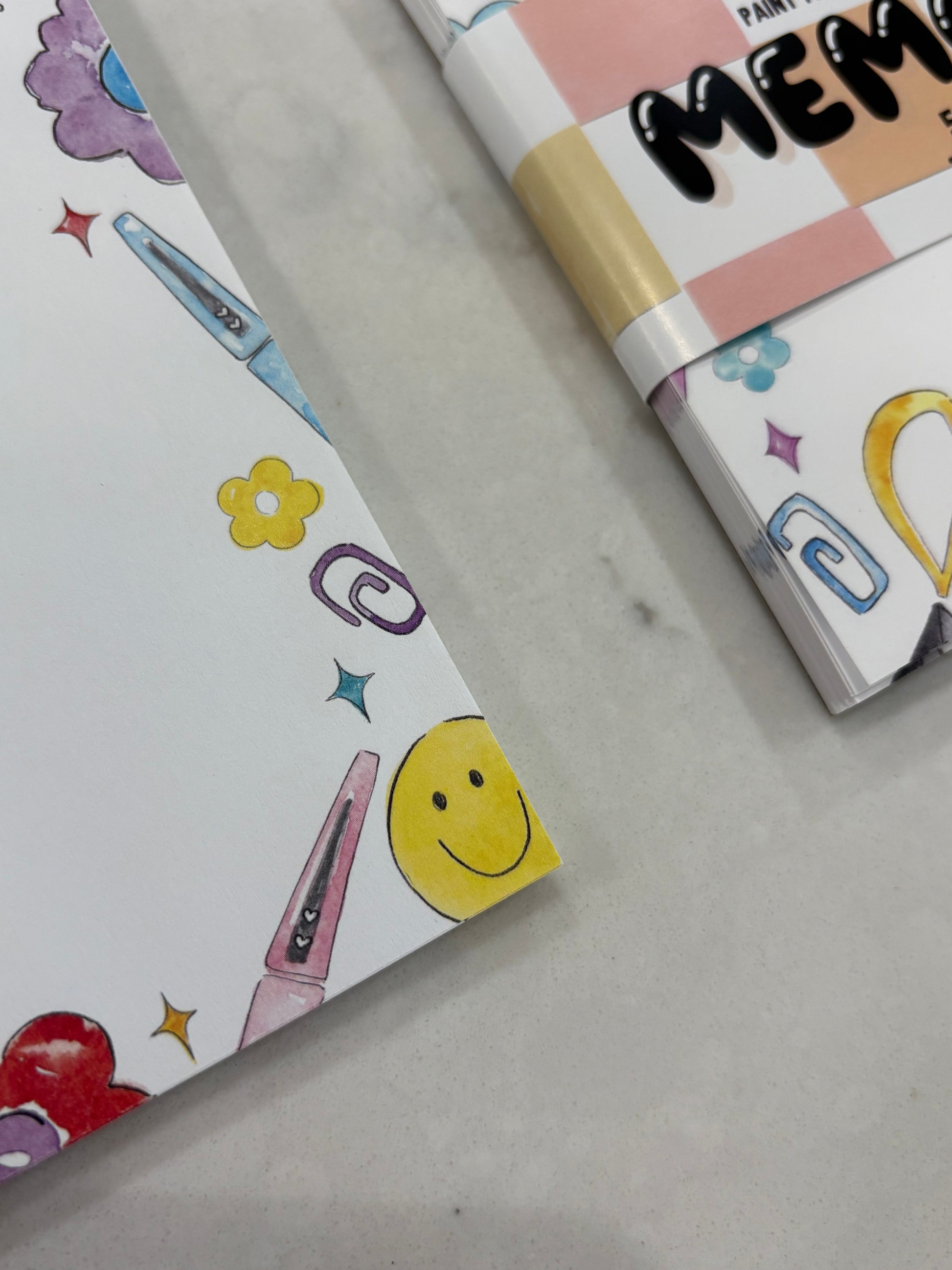 Colorful stationery items with colorful designs on a gray surface