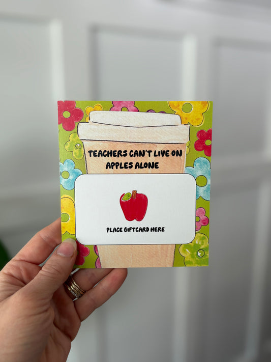 Gift card holder with apple design and text, held by a hand against a white background