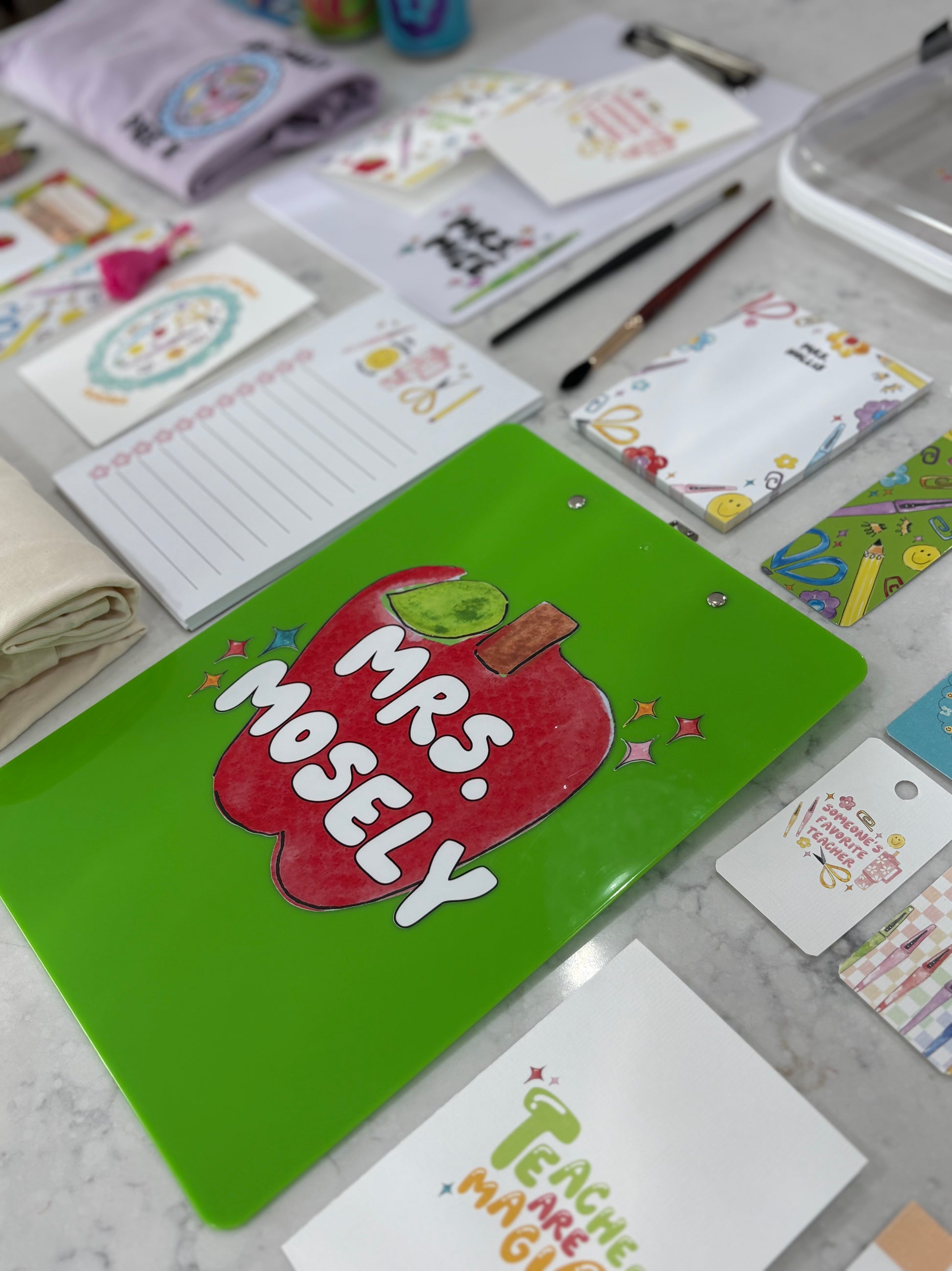 Collection of stationery items including notebooks and cards on a marble surface
