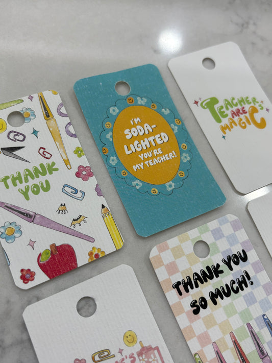 Colorful gift tags with various designs on a marble surface