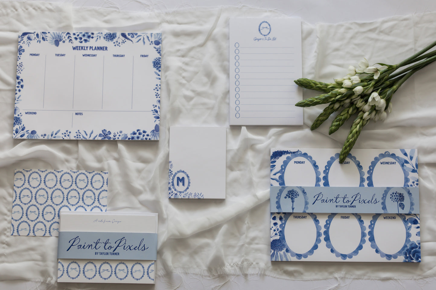 Stationery items with blue floral patterns on a textured surface