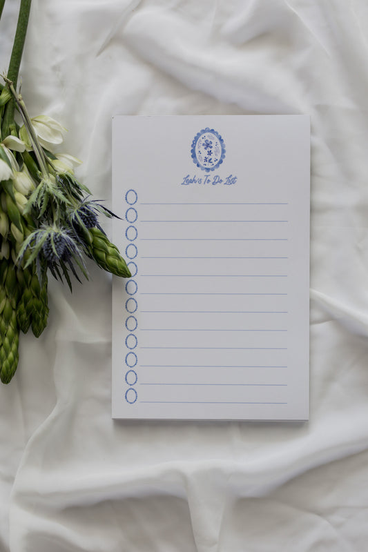 Notepad with a floral design on a white fabric background