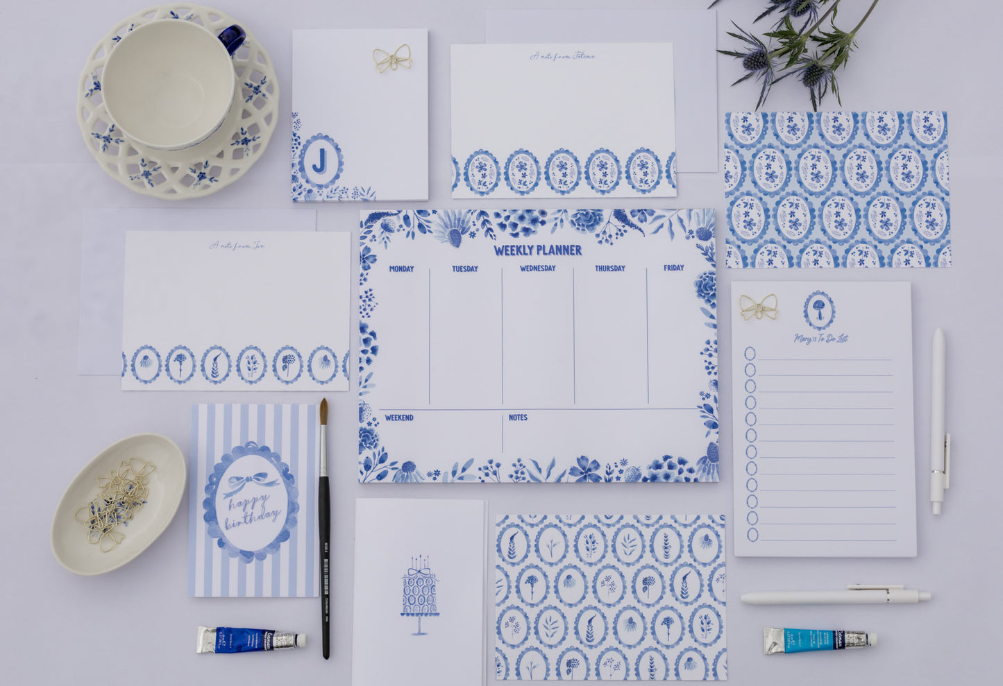 Collection of blue and white patterned stationery items on a white background
