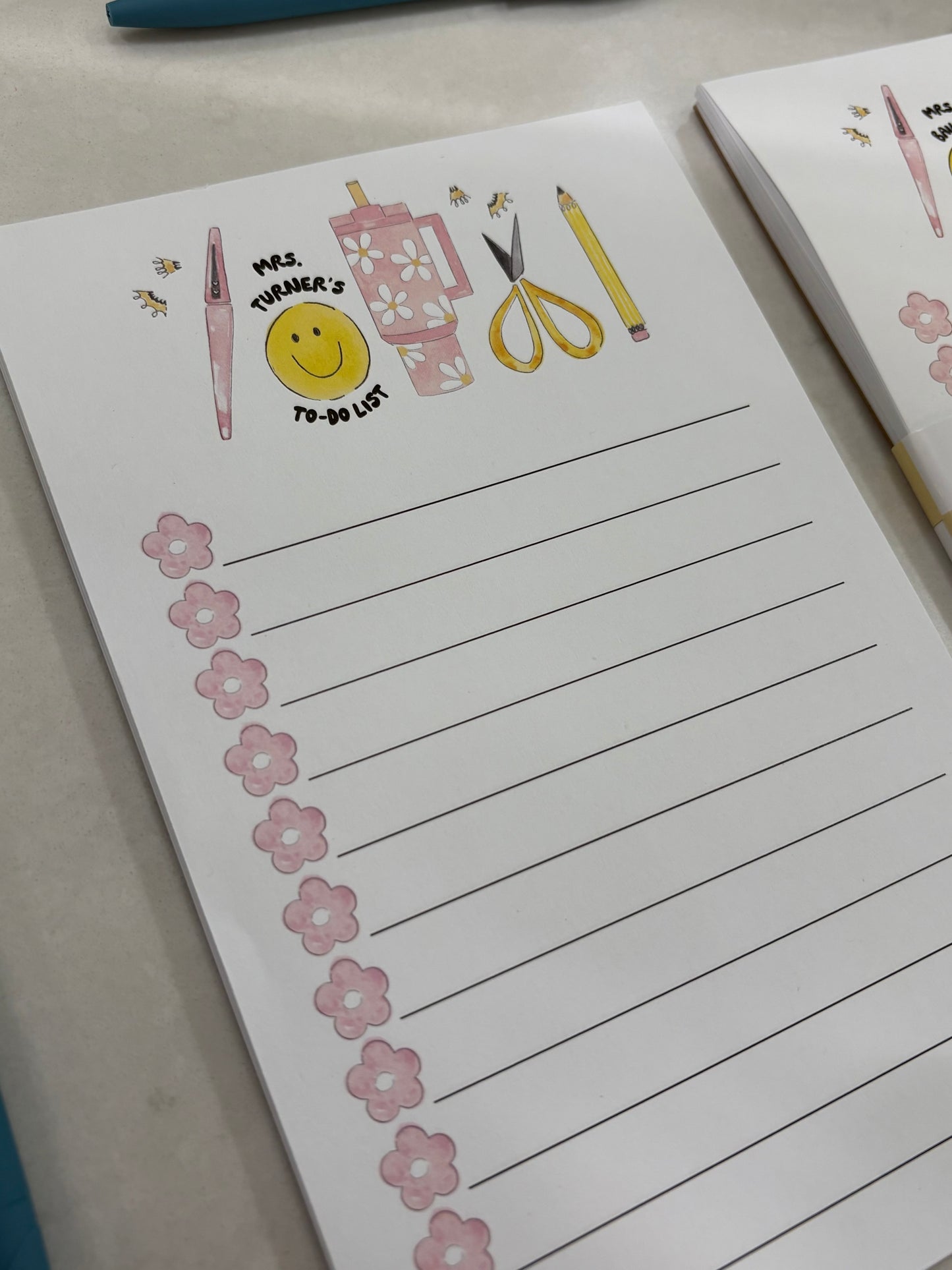 Notebook with decorative elements and a smiley face on a white surface