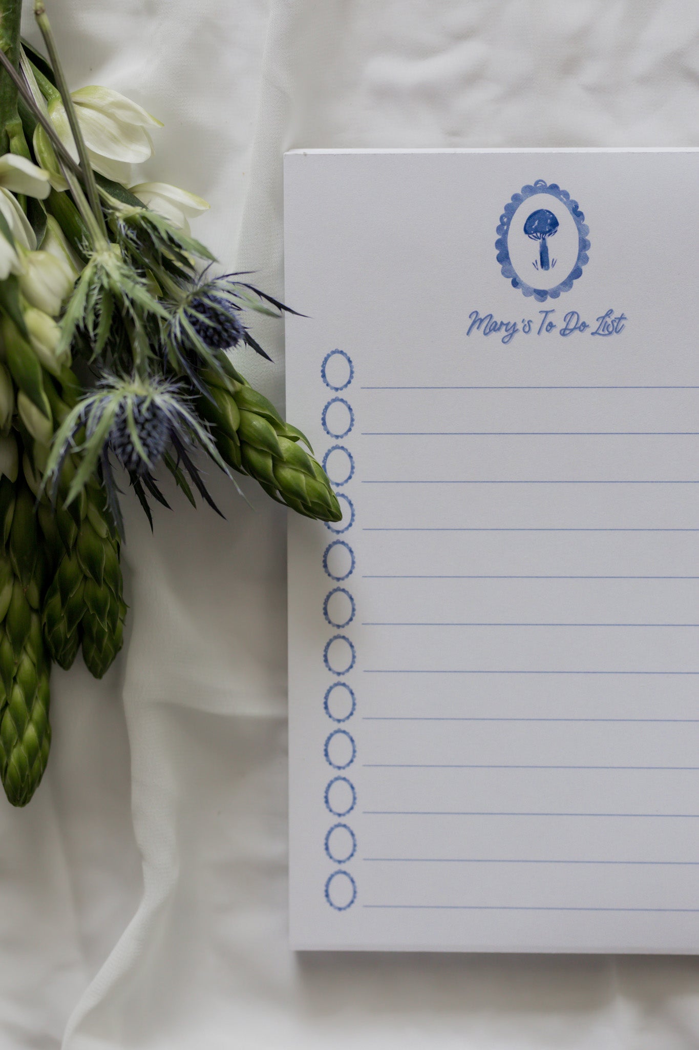 Notepad with a floral arrangement on a white background