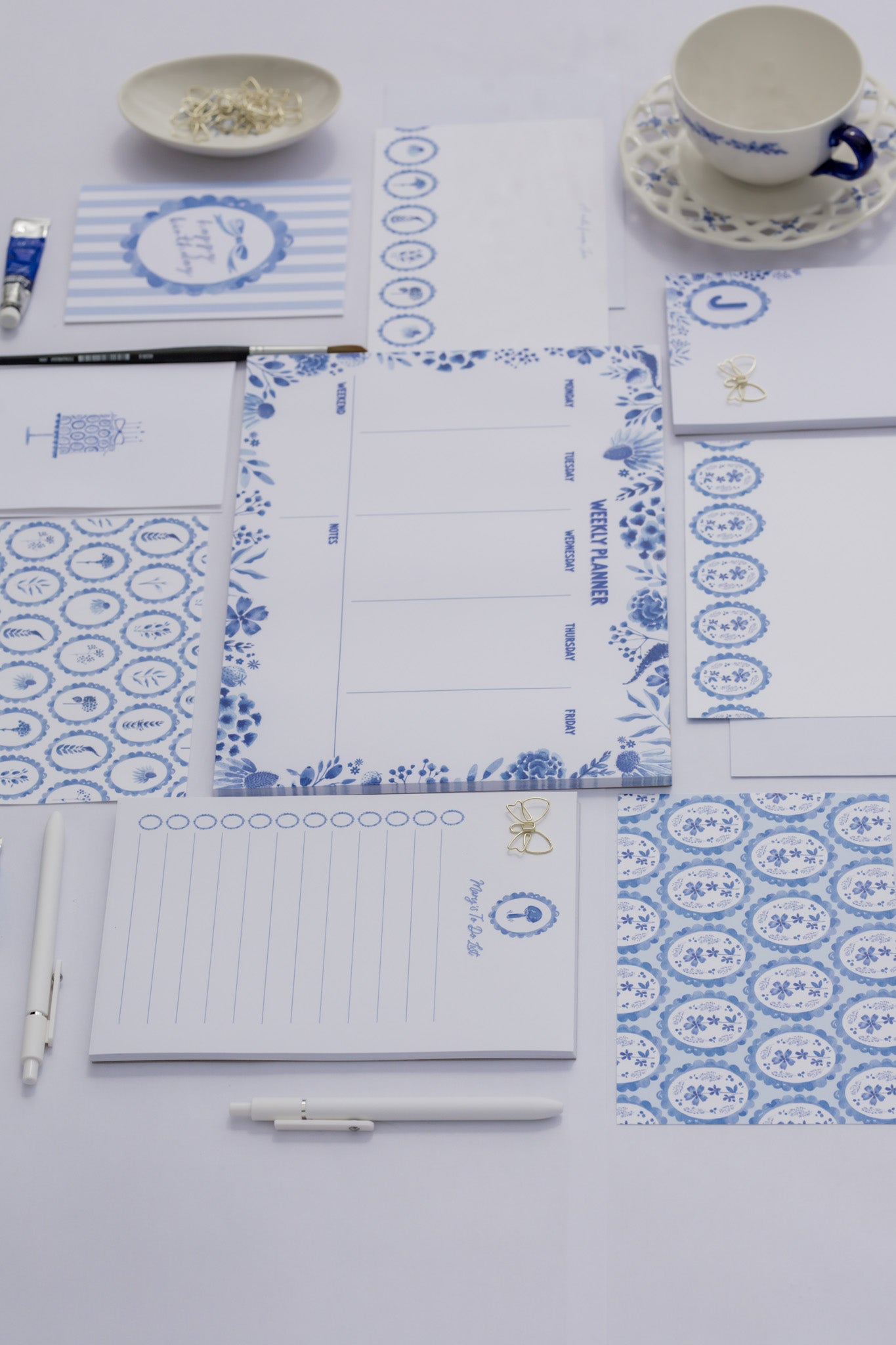 Stationery items with blue and white patterns on a white surface