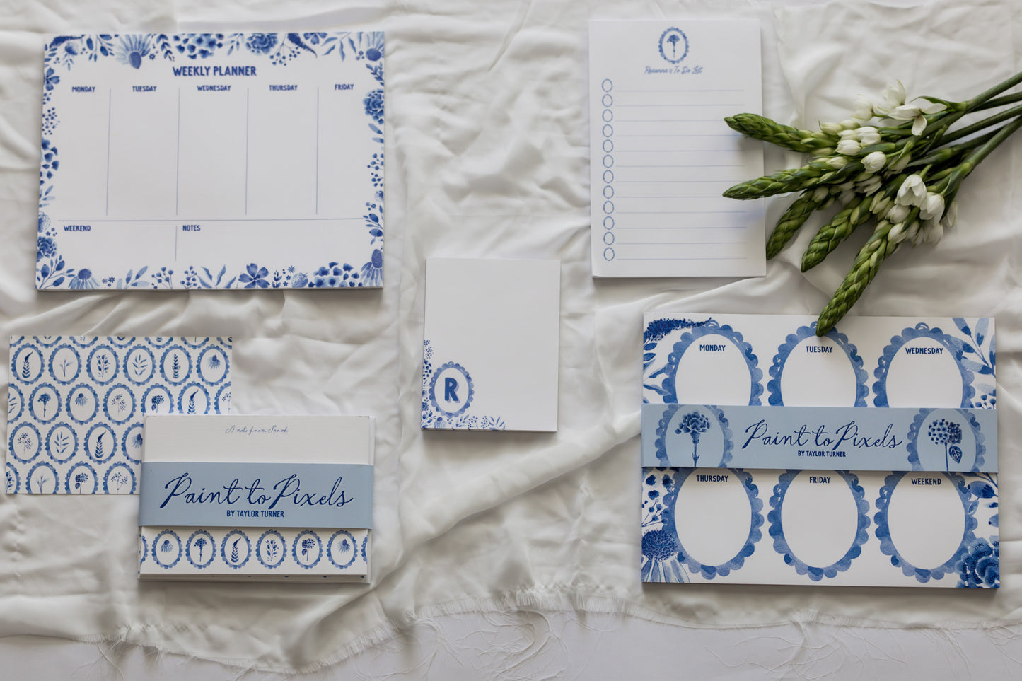 Stationery items with blue floral designs on a textured surface