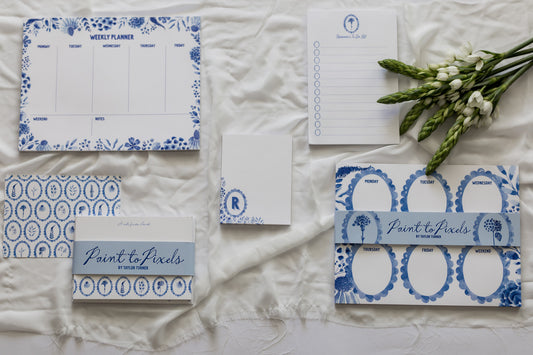 Stationery items with blue floral designs on a textured surface
