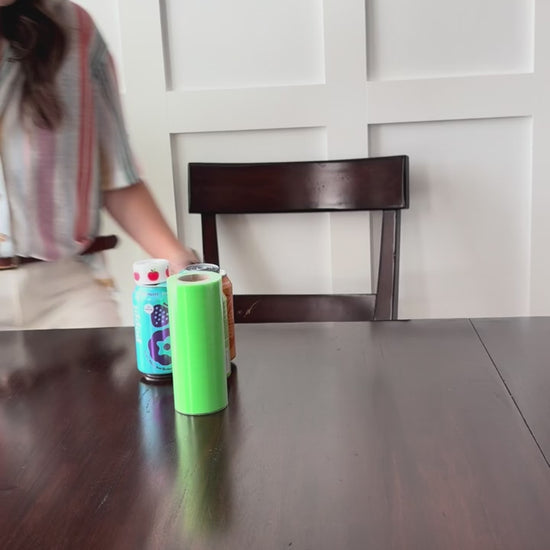 tutorial on how to use the teacher appreciation tag. Using 3 soda cans, ribbon, and tags. Woman sitting at a brown table with a white background